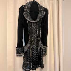 Women’s black cardigan sweater with faux leather detailing.